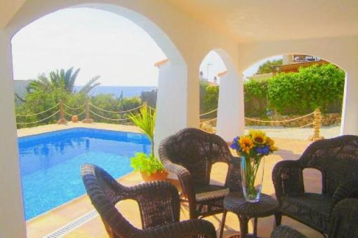 Covered terrace with view to the pool and the sea
