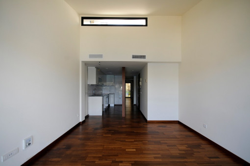 The kitchen is located directly on the bright living room
